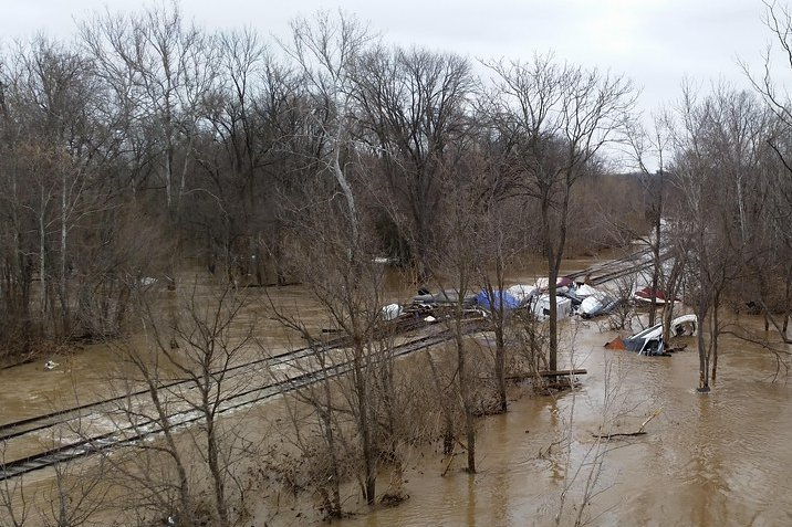 Standing floodwater along a roadside curb