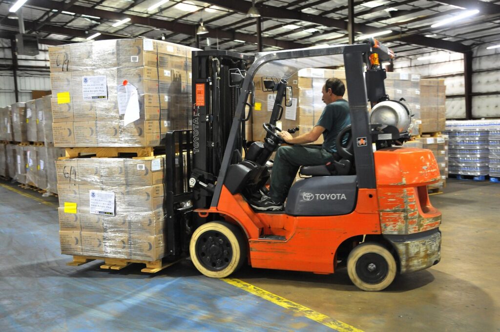 Forklift moving pallets in a warehouse